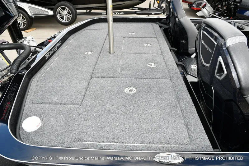 Slide: The Image of 2023 Ranger Z520R boat deck with gray carpet and storage compartments. - 40