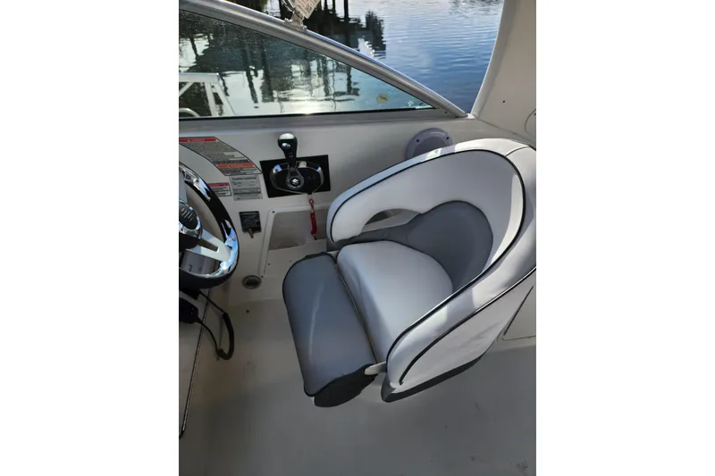 Slide: The Image of Captain's seat on 2003 Sea Ray Sundancer 260 boat, featuring sleek design and controls. - 11