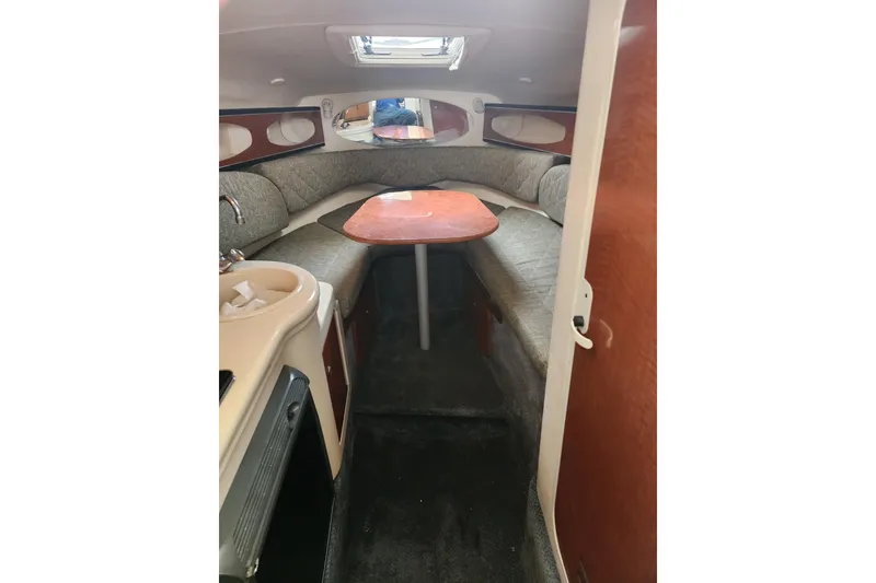 Slide: The Image of 2003 Sea Ray Sundancer 260 cabin interior with seating and table. - 14