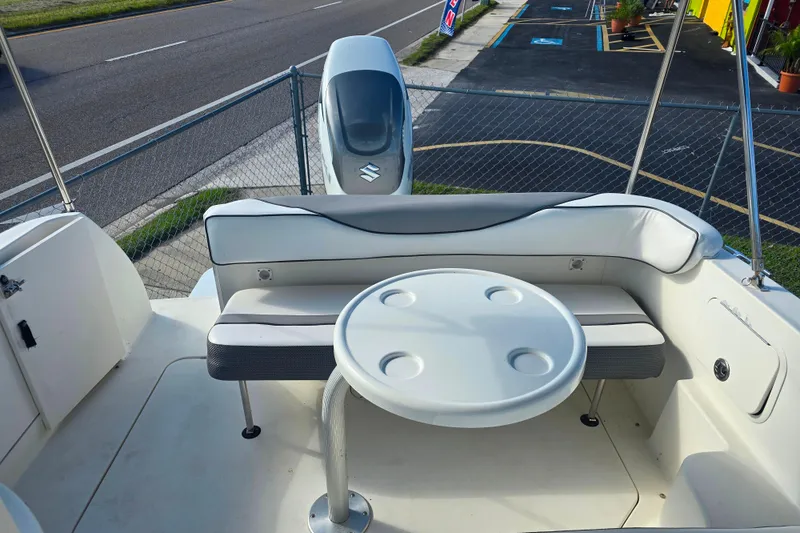 Slide: The Image of 2003 Sea Ray Sundancer 260 boat interior with seating and round table. - 15