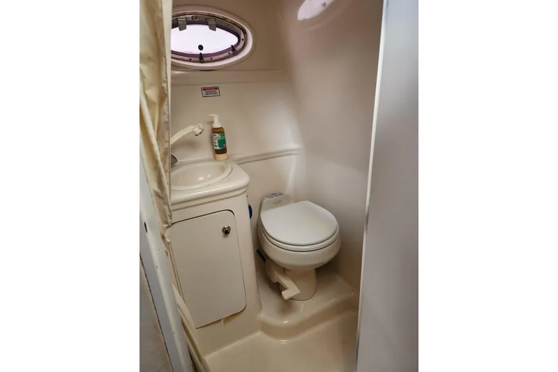 Slide: The Image of 2003 Sea Ray Sundancer 260 boat bathroom with sink and toilet. - 16