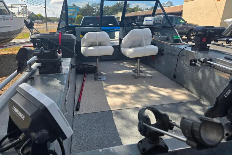 Slide: The Image of Interior of a 1997 Westcoaster 17 boat with white seats and fishing equipment. - 5