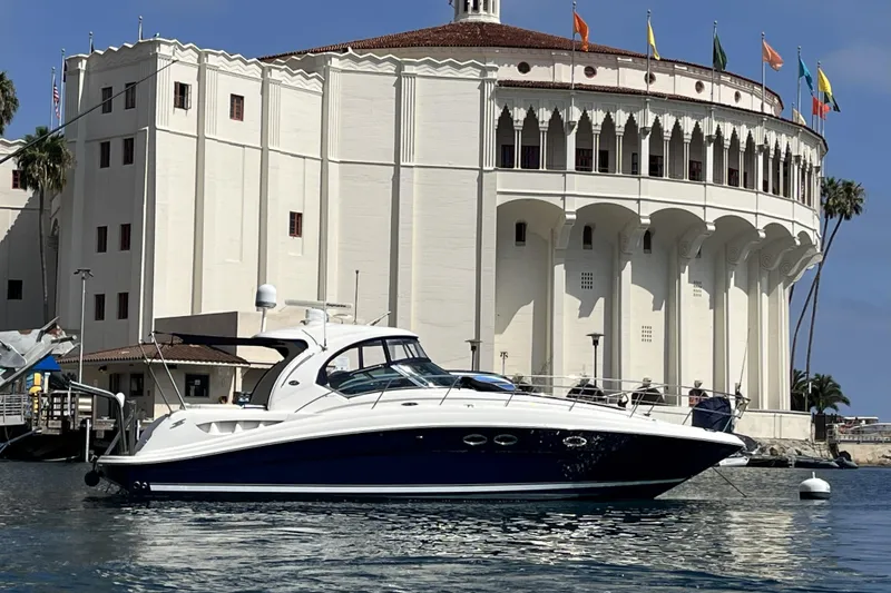 The Image of 2005 Sea Ray 390 Sundancer yacht docked near historic building with flags. - 0