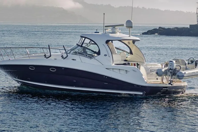 Slide: The Image of 2005 Sea Ray 390 Sundancer yacht cruising on calm waters. - 1