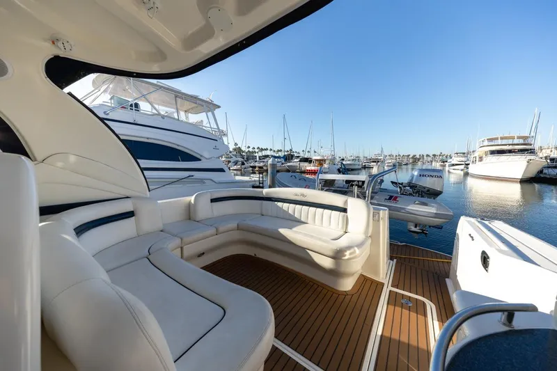 Slide: The Image of Luxurious 2005 Sea Ray 390 Sundancer yacht interior at marina, featuring elegant seating. - 11