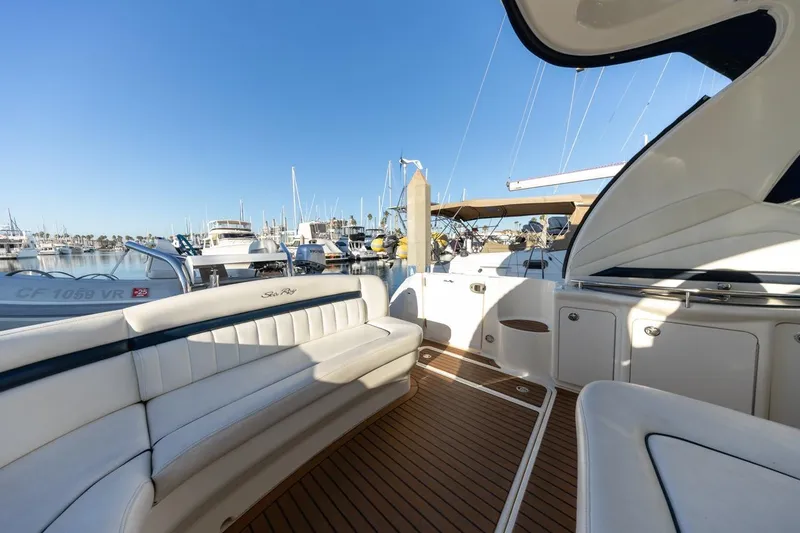 Slide: The Image of 2005 Sea Ray 390 Sundancer yacht interior with white seating and wooden deck. - 12
