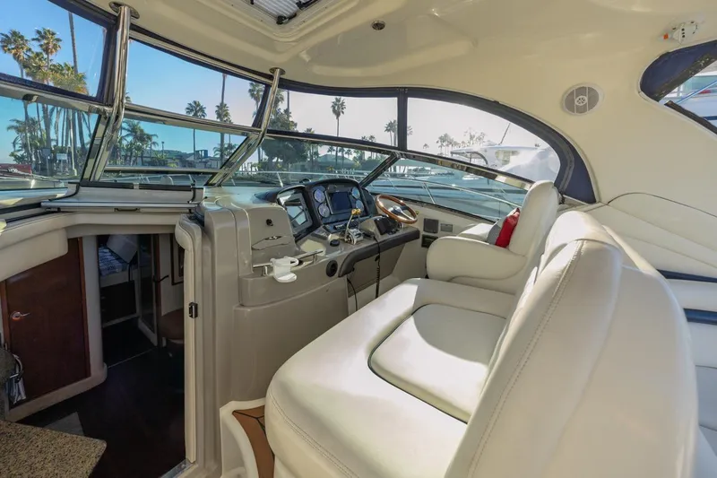 Slide: The Image of Interior of 2005 Sea Ray 390 Sundancer yacht with luxurious seating and helm. - 14