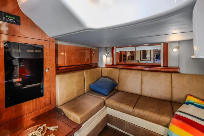 Slide: The Image of Interior of 2005 Sea Ray 390 Sundancer with cozy seating and wooden cabinetry. - 25