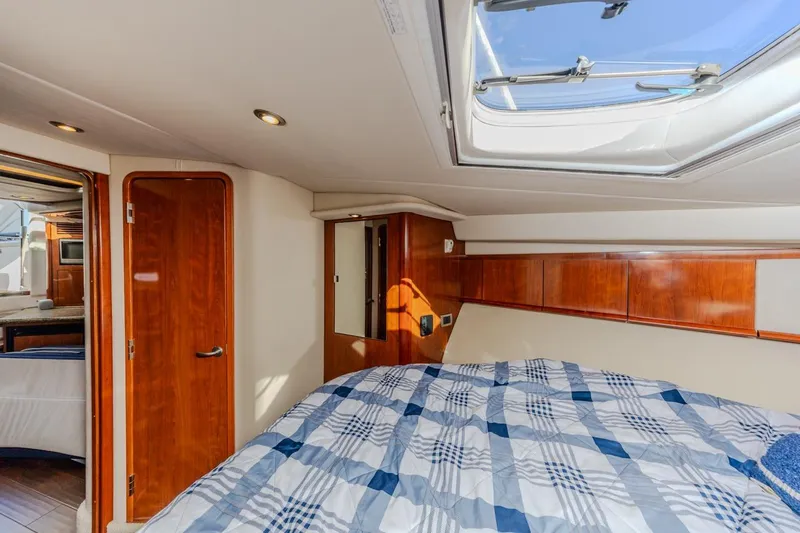 Slide: The Image of 2005 Sea Ray 390 Sundancer cabin interior with skylight and wooden accents. - 27