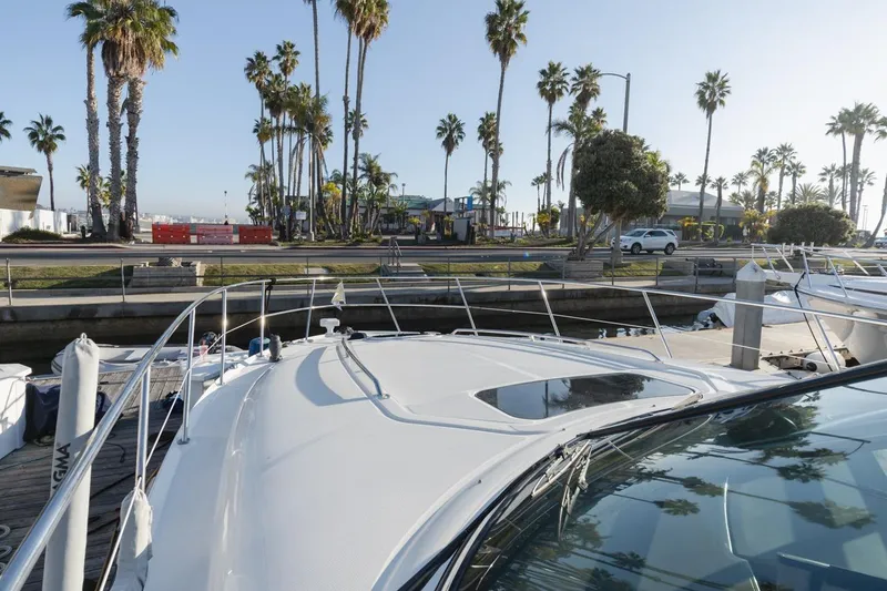 Slide: The Image of 2005 Sea Ray 390 Sundancer docked near palm trees and waterfront. - 8