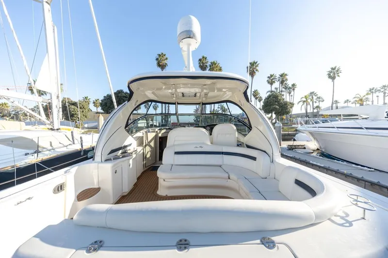 Slide: The Image of 2005 Sea Ray 390 Sundancer yacht with spacious seating, docked under clear skies. - 9