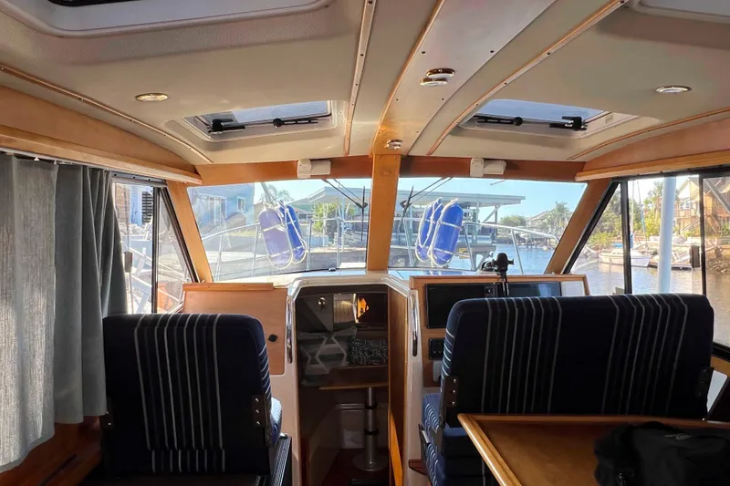 Slide: The Image of Interior view of a 2012 Cutwater 26 boat with striped seating and navigation equipment. - 17