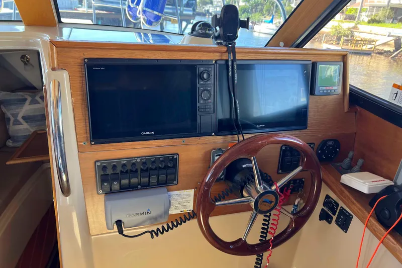 Slide: The Image of Interior helm of 2012 Cutwater 26 boat with Garmin navigation system. - 18