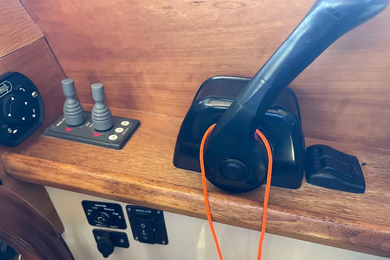 Slide: The Image of Control panel of a 2012 Cutwater 26 boat with throttle and switches. - 22