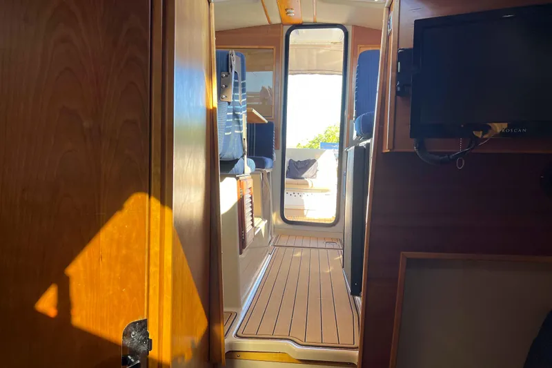 Slide: The Image of Interior view of 2012 Cutwater 26 boat, featuring wooden flooring and seating. - 27