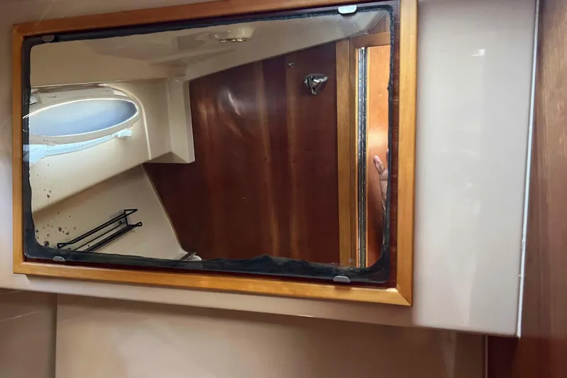 Slide: The Image of Interior of 2012 Cutwater 26 boat with mirror and wooden paneling. - 29