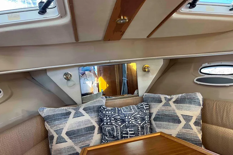 Slide: The Image of Cozy interior of 2012 Cutwater 26 boat with patterned cushions and wooden accents. - 31