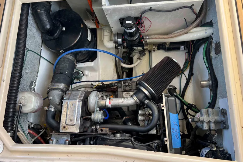Slide: The Image of Engine compartment of a 2012 Cutwater 26 boat, showcasing mechanical components and wiring. - 37