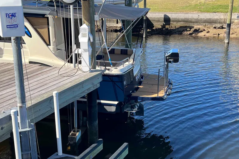 Slide: The Image of 2012 Cutwater 26 boat docked at a marina with clear water. - 4