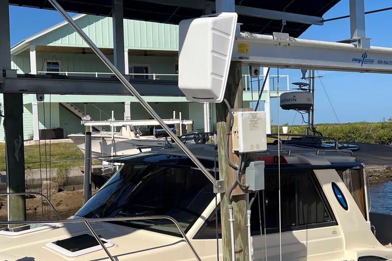 Slide: The Image of 2012 Cutwater 26 boat docked near a waterfront house with marine equipment. - 5