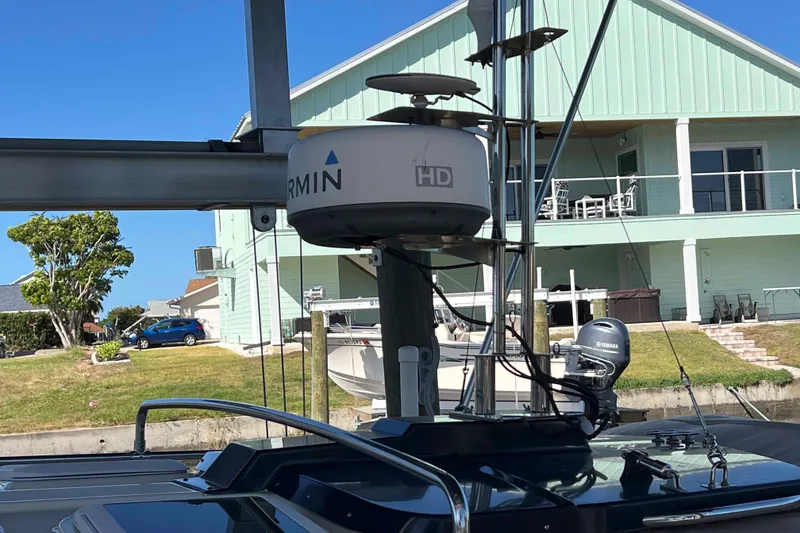 Slide: The Image of 2012 Cutwater 26 boat with Garmin HD radar, docked near a house. - 6