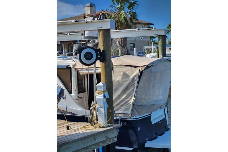 Slide: The Image of 2012 Cutwater 26 boat docked with protective cover and marina equipment. - 8