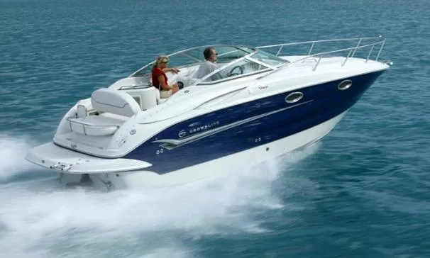 The Image of 2006 Crownline 250 CR boat docked at marina, covered with blue tarp. - 0