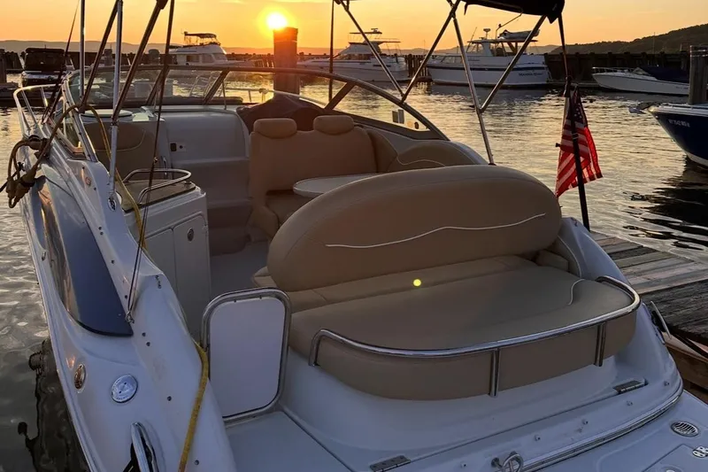 Slide: The Image of 2006 Crownline 250 CR boat docked at sunset with American flag. - 4