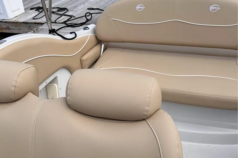 Slide: The Image of Luxurious beige seating on a 2006 Crownline 250 CR boat, dockside view. - 5
