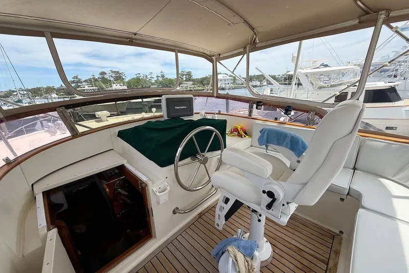 Slide: The Image of Helm of 1998 Krogen Express 49 yacht with steering wheel and navigation equipment. - 11