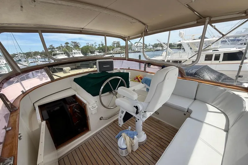 Slide: The Image of Helm of 1998 Krogen Express 49 yacht with steering wheel and seating area. - 13