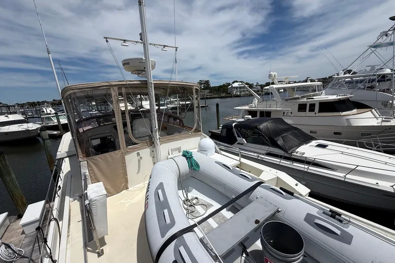 Slide: The Image of 1998 Krogen Express 49 yacht docked with inflatable boat on deck. - 14