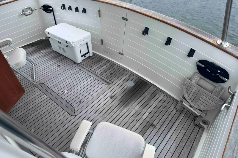 Slide: The Image of Deck of 1998 Krogen Express 49 with chairs and cooler, overlooking water. - 16