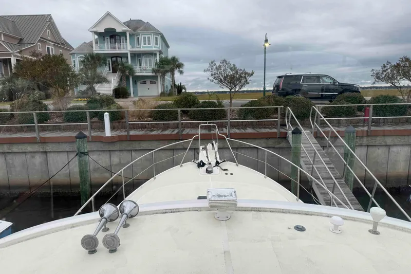 Slide: The Image of Inflatable dinghy with motor on Krogen Express 49, docked at marina, 1998 model. - 22