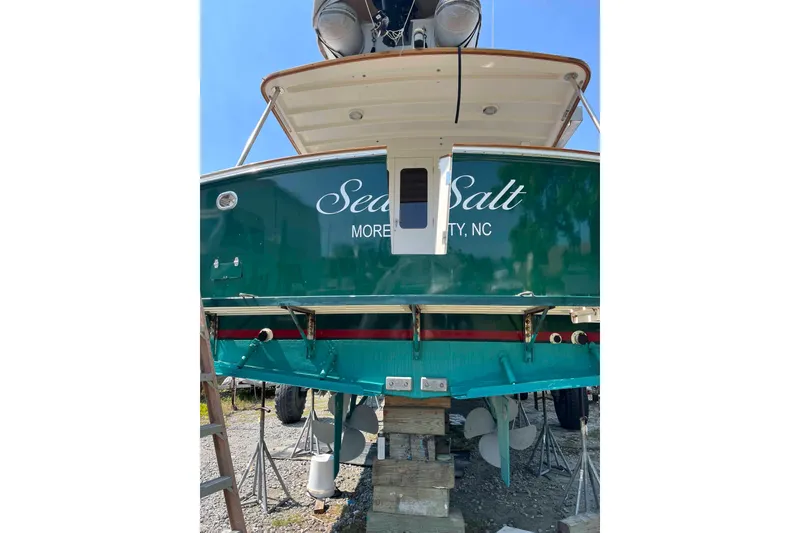 Slide: The Image of Side view of a 1998 Krogen Express 49 yacht docked at a marina. - 24