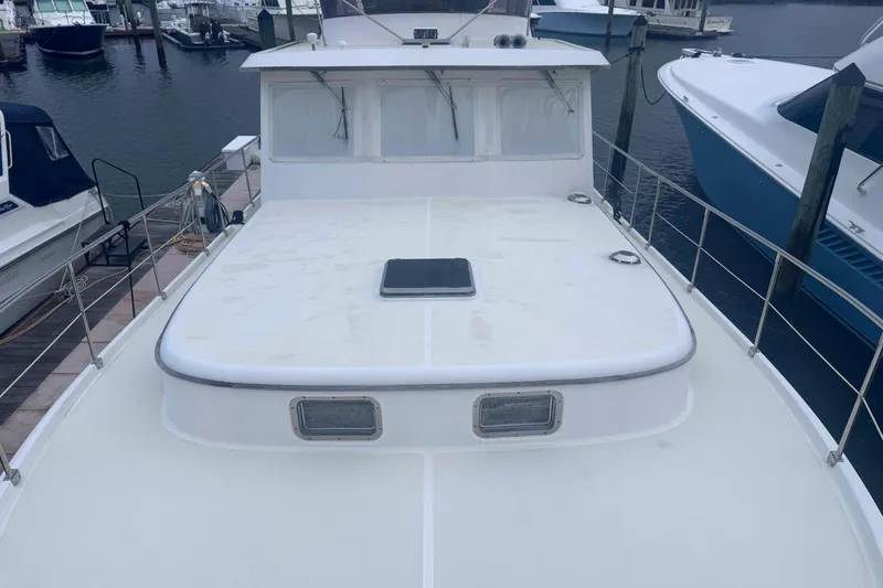 Slide: The Image of Bow view of 1998 Krogen Express 49 yacht docked near a wooden walkway. - 3