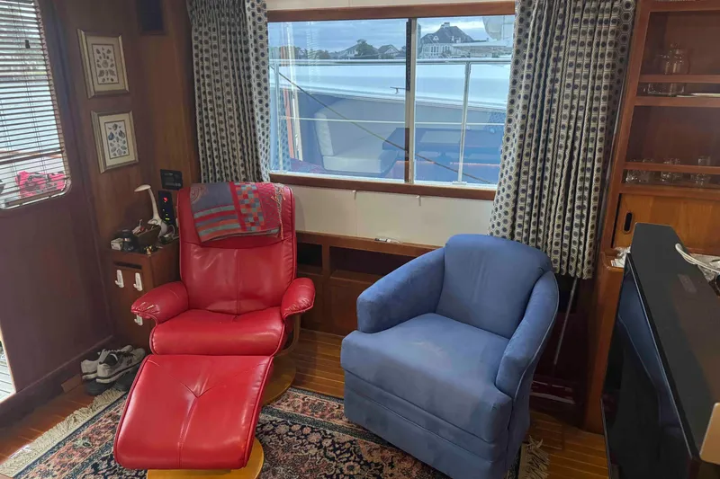 Slide: The Image of Cozy cabin interior of 1998 Krogen Express 49 with bed, lamp, and wooden cabinetry. - 43