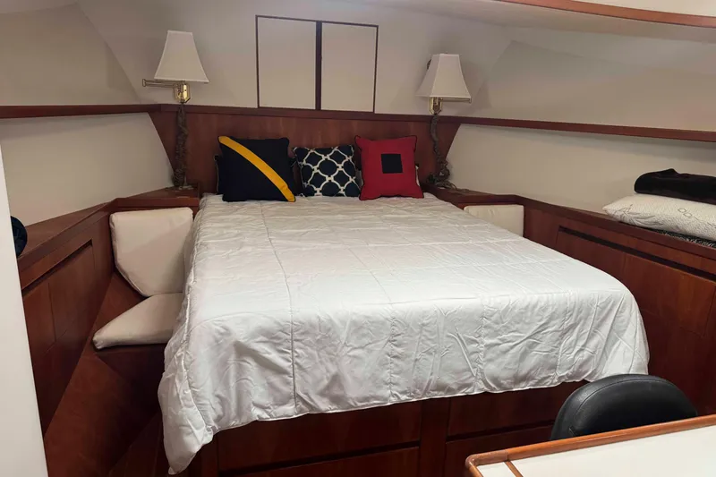Slide: The Image of Wooden staircase inside 1998 Krogen Express 49 boat, featuring storage and safety grips. - 49