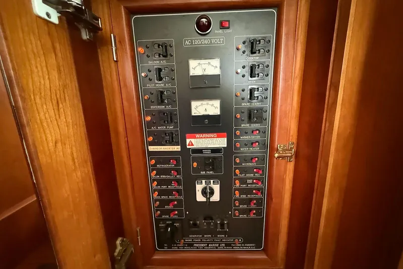 Slide: The Image of Electrical panel on a 1998 Krogen Express 49 boat, featuring various switches and gauges. - 62