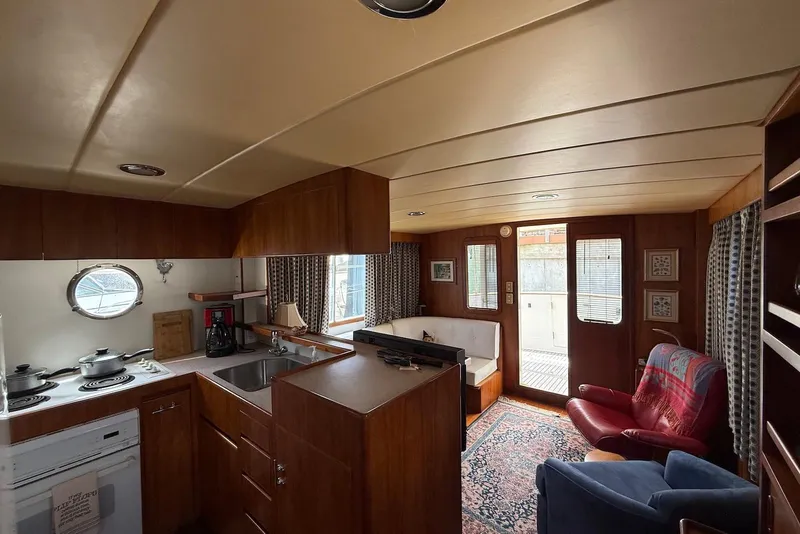 Slide: The Image of Interior of 1998 Krogen Express 49 yacht with cozy seating and kitchen area. - 63