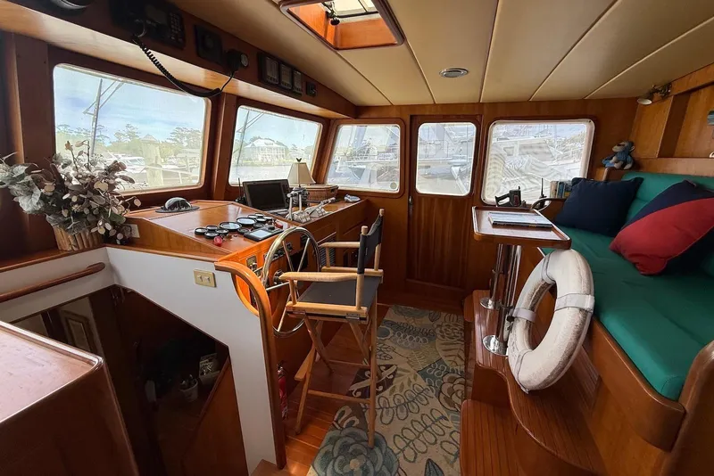 Slide: The Image of 1998 Krogen Express 49 yacht interior with helm, seating, and nautical decor. - 64