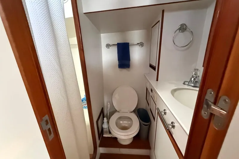 Slide: The Image of Bathroom interior of 1998 Krogen Express 49 yacht, featuring toilet, sink, and towel rack. - 66