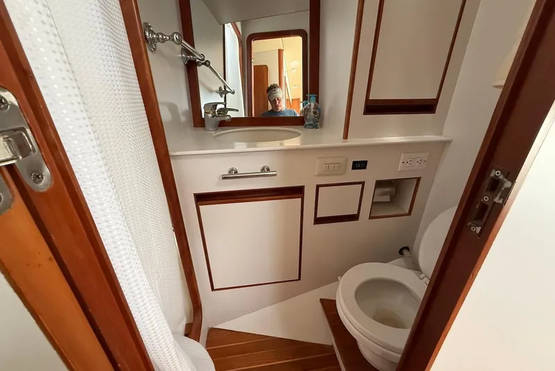 Slide: The Image of Bathroom interior of 1998 Krogen Express 49 yacht, featuring sink, mirror, and toilet. - 70