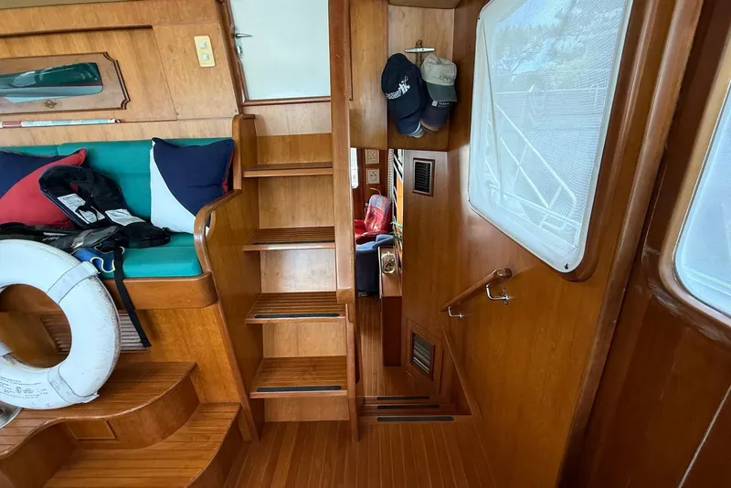Slide: The Image of Interior of 1998 Krogen Express 49 yacht with wooden stairs and seating area. - 71
