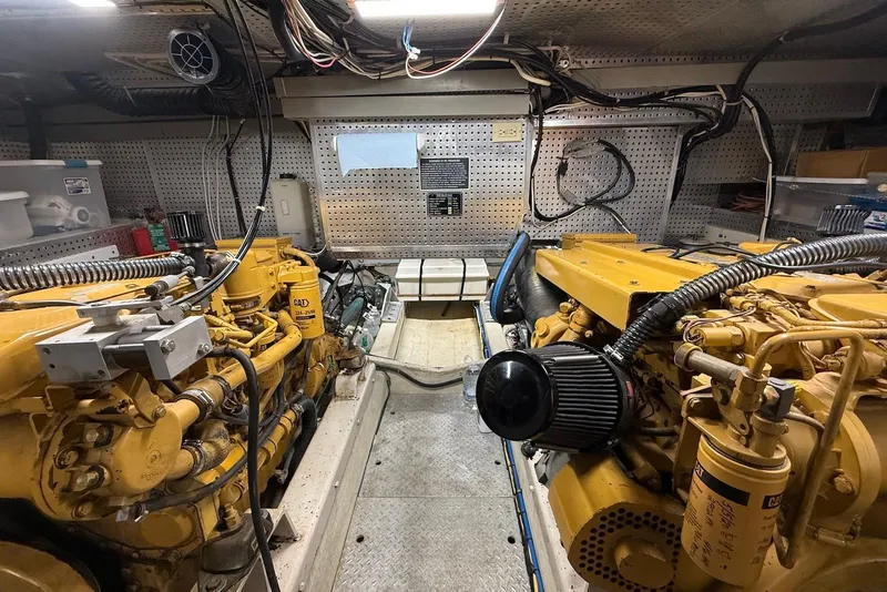 Slide: The Image of Engine room of a 1998 Krogen Express 49 yacht, featuring dual Caterpillar engines. - 73