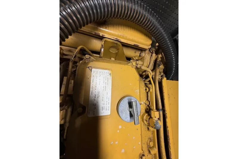 Slide: The Image of Engine compartment of a 1998 Krogen Express 49 boat, showcasing mechanical components and labels. - 78