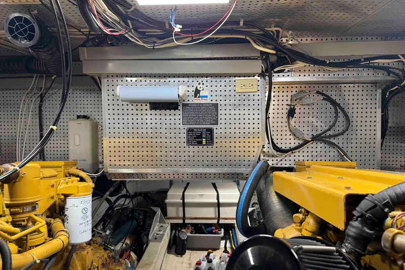 Slide: The Image of Engine room of 1998 Krogen Express 49 with visible mechanical components and piping. - 83