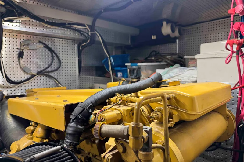 Slide: The Image of Engine room of a 1998 Krogen Express 49 with visible mechanical components. - 84