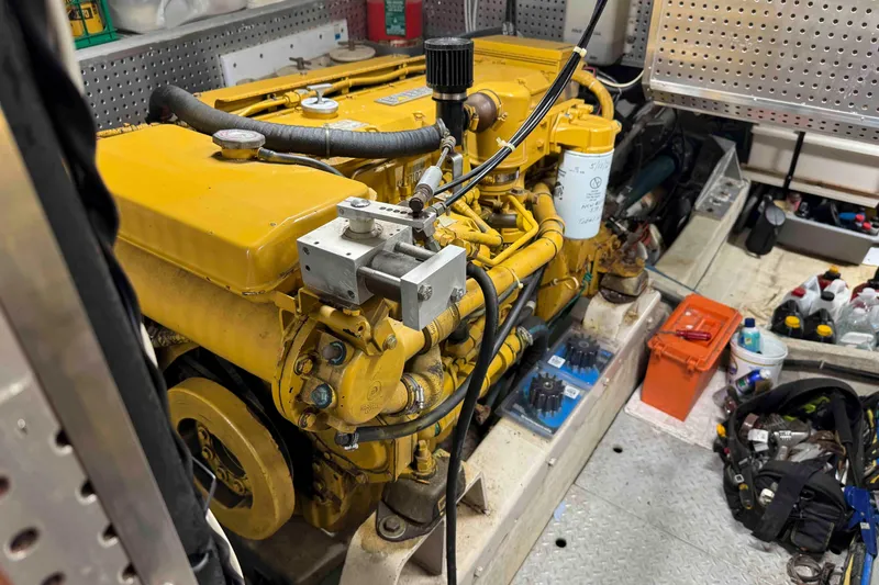 Slide: The Image of Engine compartment of a 1998 Krogen Express 49, showing mechanical components and hoses. - 86