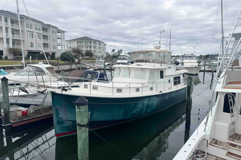 Slide: The Image of 1998 Krogen Express 49 yacht on dry dock under clear blue sky. - 87